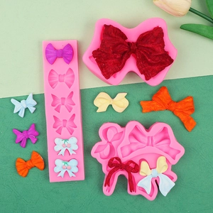 Three pink silicone molds for making detailed 3D bows in various sizes and shapes