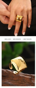 Macro detail of gold-plated square ring featuring unique hammered texture and open design