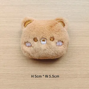 Detailed view of plush brown bear accessory with size dimensions 5cm high by 5.5cm wide