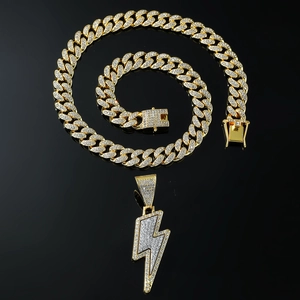 Detail of gold Cuban link chain and iced out lightning pendant with zircon stones