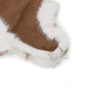 Detailed close-up of brown suede fabric and thick white faux fur lining on winter hat