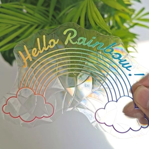 Rainbow and cloud static window decal with Hello Rainbow text held against green plants