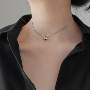 Minimalist silver Lucky pendant necklace with 18k finish on a stylish model neck