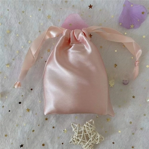 Pink satin drawstring bag with silk ribbons for jewelry and cosmetic gift storage