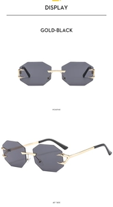 Detail view of rimless octagonal sunglasses with gold metal eagle claw temples