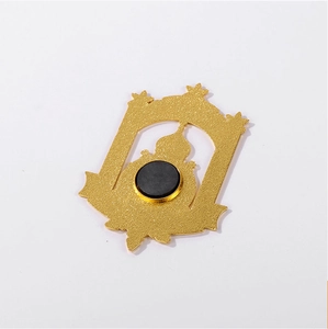 Golden metal Harbin souvenir fridge magnet showing the back side with a round black magnet