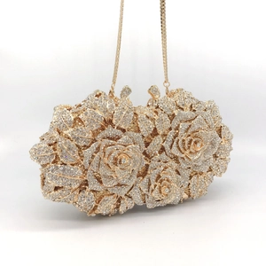 Detail view of a luxury gold rose-shaped evening bag encrusted with sparkling rhinestones
