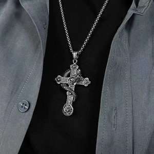 Gothic silver-toned cross necklace with dragon and skull pendant worn on model