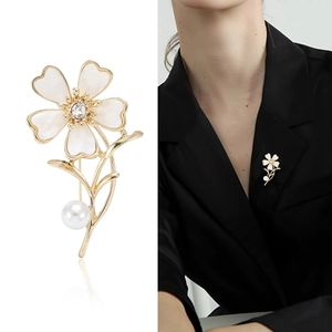 Elegant white flower brooch with gold plating, crystal center and pearl accent for women