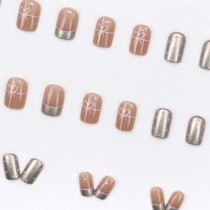 Pink French press-on nails with white bows, silver mirror finish and purple polka dots