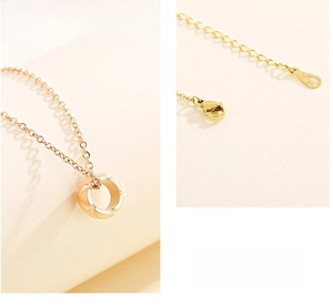 Macro view of 18K gold-plated pendant necklace showing lobster clasp and extender details