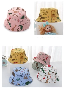 Detail of cartoon dinosaur print and breathable cotton fabric on kids sun bucket hats