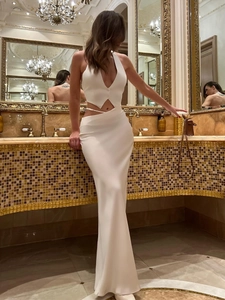 Détail d'un ensemble blanc deux pièces avec gilet dos nu et jupe longue en satin