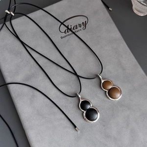 Modern resin gourd necklace in black and brown leather texture with silver metal frame