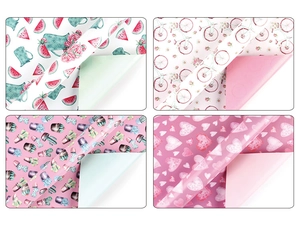 Detail showing four assorted floral and fruit print gift wrapping paper sheets