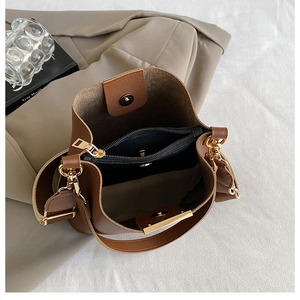 Detailed top view of brown bucket bag interior showing zip pocket and magnetic closure