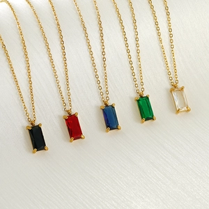 Five colored zircon square pendants on gold stainless steel chains over white silk