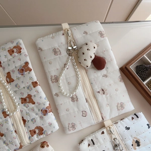 Quilted cotton fabric detail featuring vintage floral and cute bear patterns with zipper
