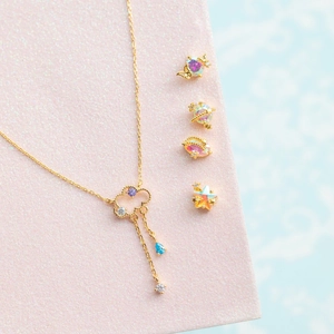 Detailed set of 18K gold plated celestial jewelry with cloud pendant and star stud earrings