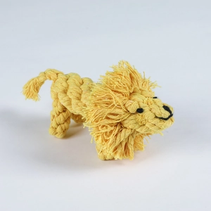 Detailed macro view of yellow hand-woven cotton rope lion pet toy for dog dental care