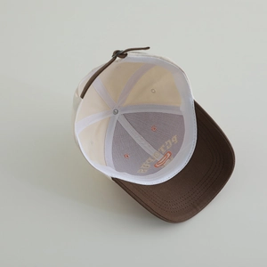 Detailed interior of color-block cotton baseball cap with embroidery and adjustable strap