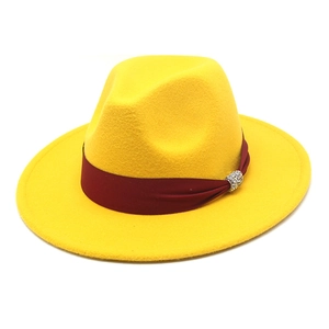 Detailed macro view of yellow wool fedora hat with burgundy ribbon and crystal buckle