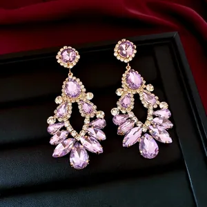 Elegant drop earrings featuring purple faceted crystals and sparkling pavé accents