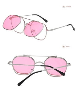 Detail view of pink lens flip-up sunglasses with silver metal frame and double bridge design