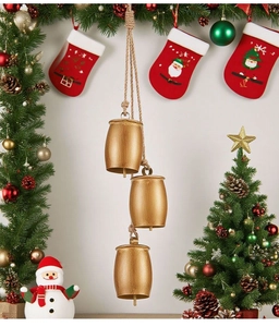 Detail of three vintage gold metal bells hanging with natural jute rope on festive background