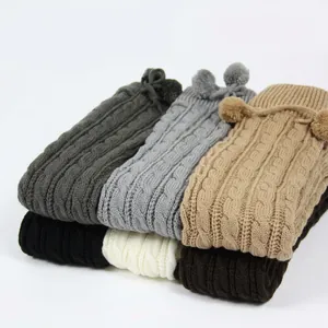 Thick cable knit leg warmers with pompoms in multiple colors for winter comfort