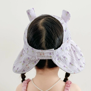 Detail showing lavender bunny print kids sun hat with cute ears and empty top design