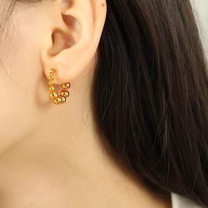 Elegant gold beaded C-shape hoop earrings for women with minimalist metallic geometric design
