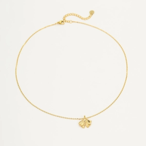 Detailed view of the 18K gold-plated ginkgo leaf pendant necklace on white background
