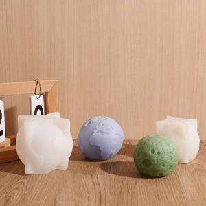 Detail showing 3D earth and moon aromatherapy candle molds with fine surface texture