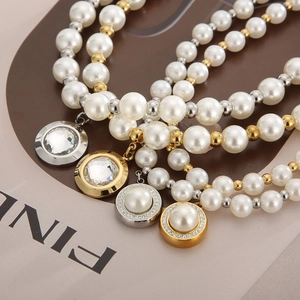 Macro detail of French style pearl bracelets with gold and silver crystal charms