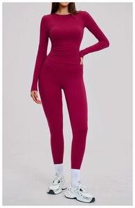 Detail view of burgundy yoga set featuring slim-fit long sleeve top and high waist leggings