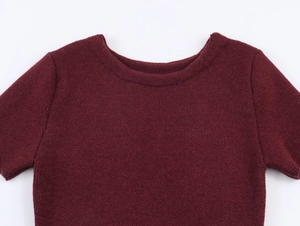 Close-up detail of burgundy knit fabric and stitching on a round neck short sleeve dress