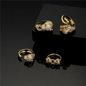 Detail showing 18K gold-plated panther rings with white zircon and green stone eyes
