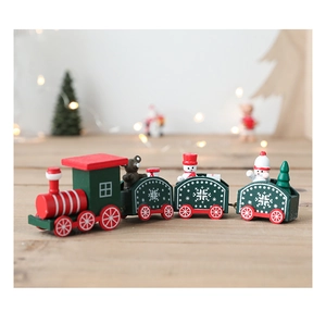 Macro detail of wooden Christmas train featuring a snowman and miniature pine tree