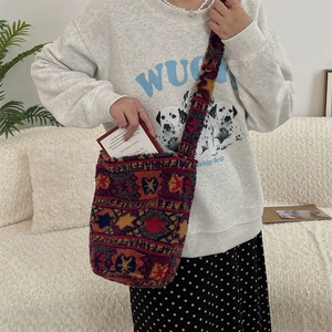 Detail of bohemian plush crossbody bag with colorful geometric woven pattern