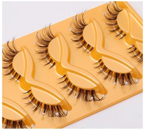 Macro shot of 4 pairs of fox-style false eyelashes with white pearl bead accents