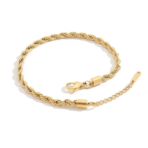 Detail of a gold rope chain anklet featuring a lobster clasp and extension links