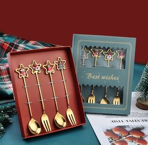 Christmas gold cutlery set with Santa and bell charms in holiday gift box packaging