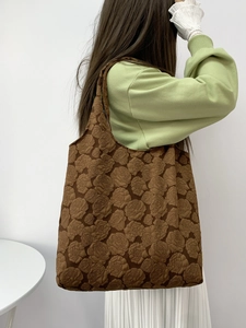 Detailed view of the brown rose jacquard texture on the minimalist shoulder tote bag