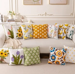 Detailed embroidery of tulip and sunflower patterns on premium floral throw pillows
