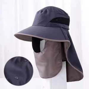 Detail of waterproof dark grey sun hat with removable neck cover and water droplets