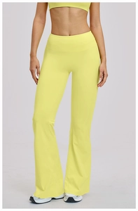 Close-up of neon yellow high-waisted flared yoga pants with elastic fitness fabric