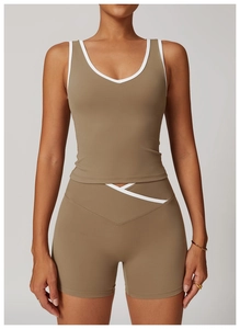 Close-up of contrast binding on deep V-neck sports tank top and cross waist shorts