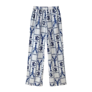 Two-piece set with lobster and crab print pants on white background flat lay