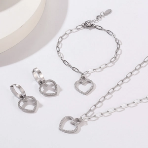 Silver jewelry set with sparkling heart pendants on paperclip chains with crystals